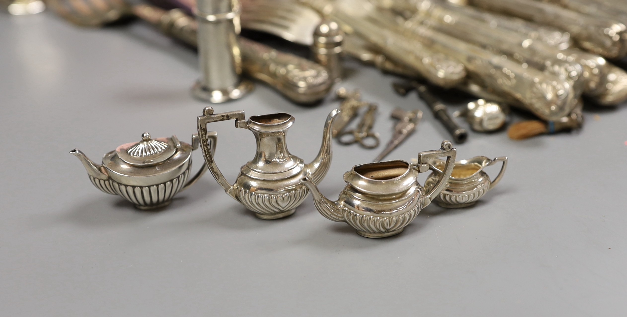 A pair of George VI silver fish servers, Carrington & Co, London 1939 and eleven pairs of matching fish eaters, together with a continental white metal skewer, a modern silver handled cake slice and cheese knife, a lady'